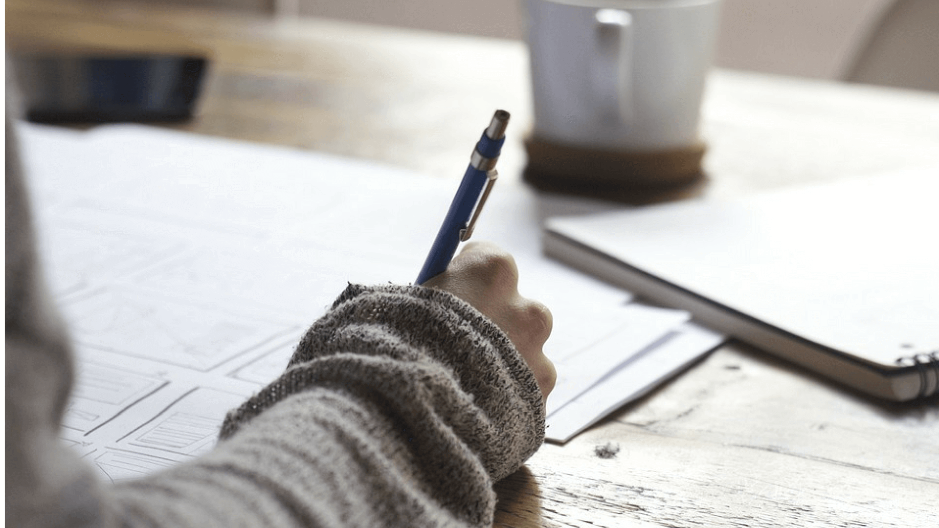 A woman writes a motivational letter as part of her application process.